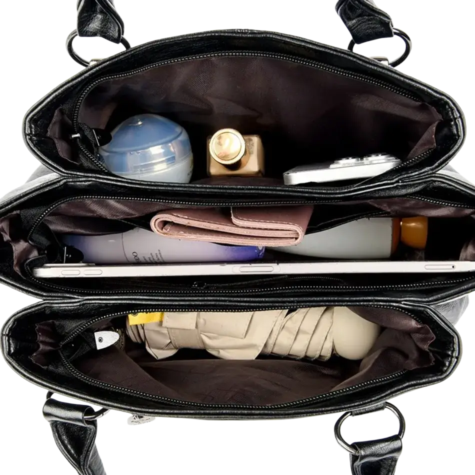 Black leather crossbody handbag with multiple compartments and sturdy handles featuring a pocket interior design