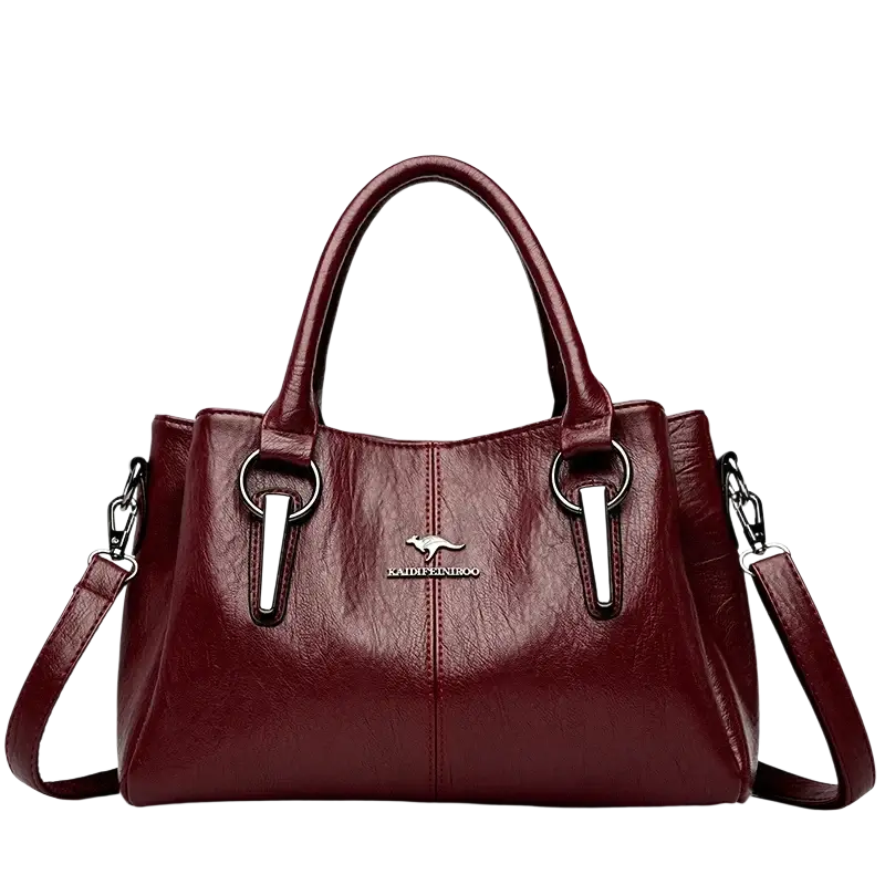Burgundy leather crossbody handbag with silver-tone accents and kangaroo logo emblem featuring pocket interior