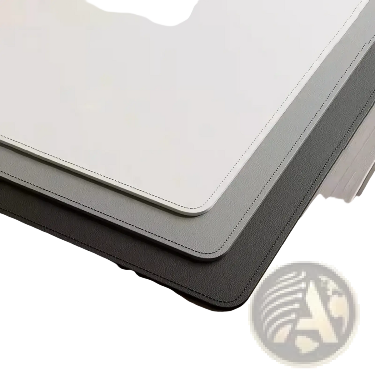 Stacked minimalist leather desk pad protectors in cream gray and black faux leather with stitched edges for office use