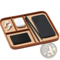 Brown leather desktop organizer tray with beige compartments holding wireless earbuds phone case and styluses minimalist bedside valet
