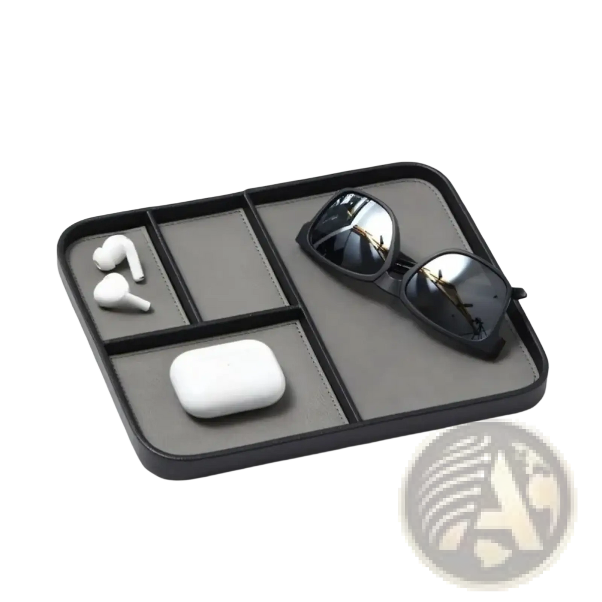 Black leather minimalist desktop organizer tray with segmented compartments holding sunglasses earbuds and charging case