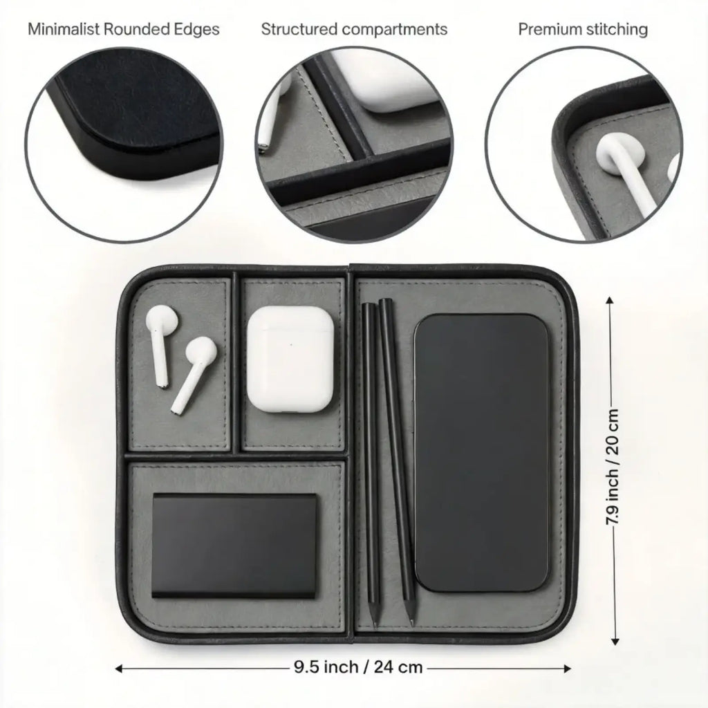 Black leather desktop organizer tray with minimalist rounded edges and compartments for earbuds phone and cards