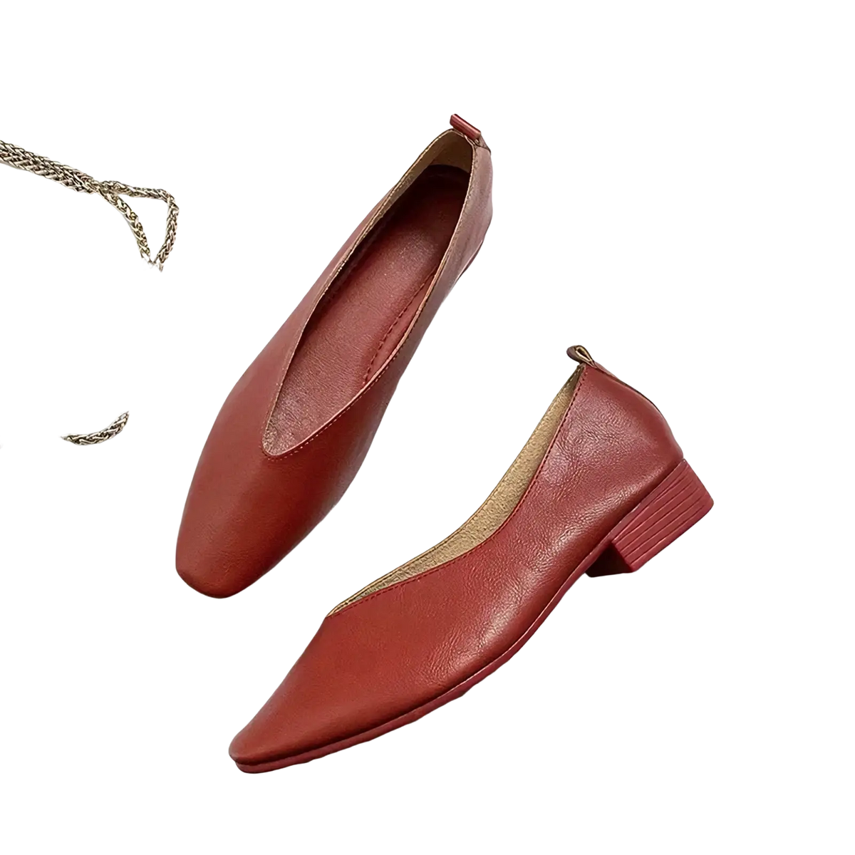 A pair of elegant red leather flat shoes for women with a pointed toe and low block heel slip on design