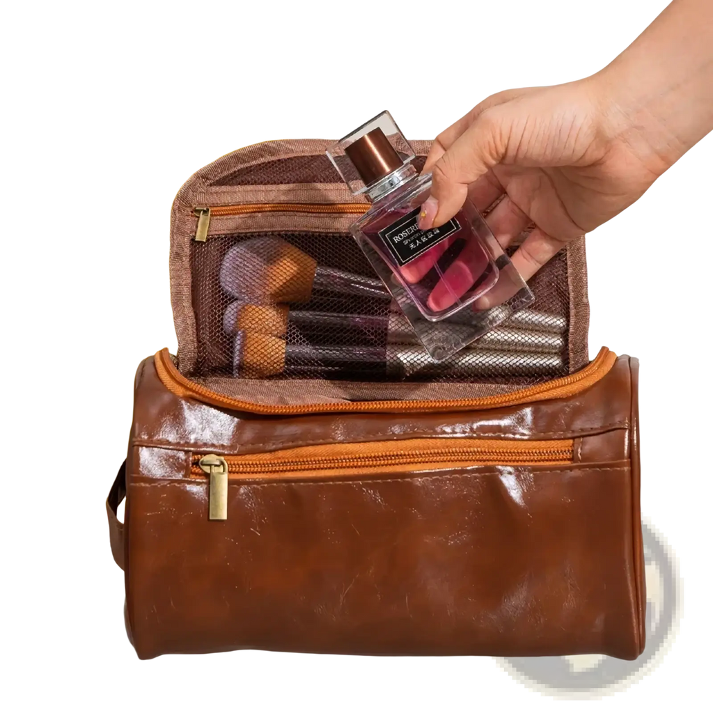 Leather hanging toiletry bag in brown leather with orange zipper accents and mesh interior compartments for travel