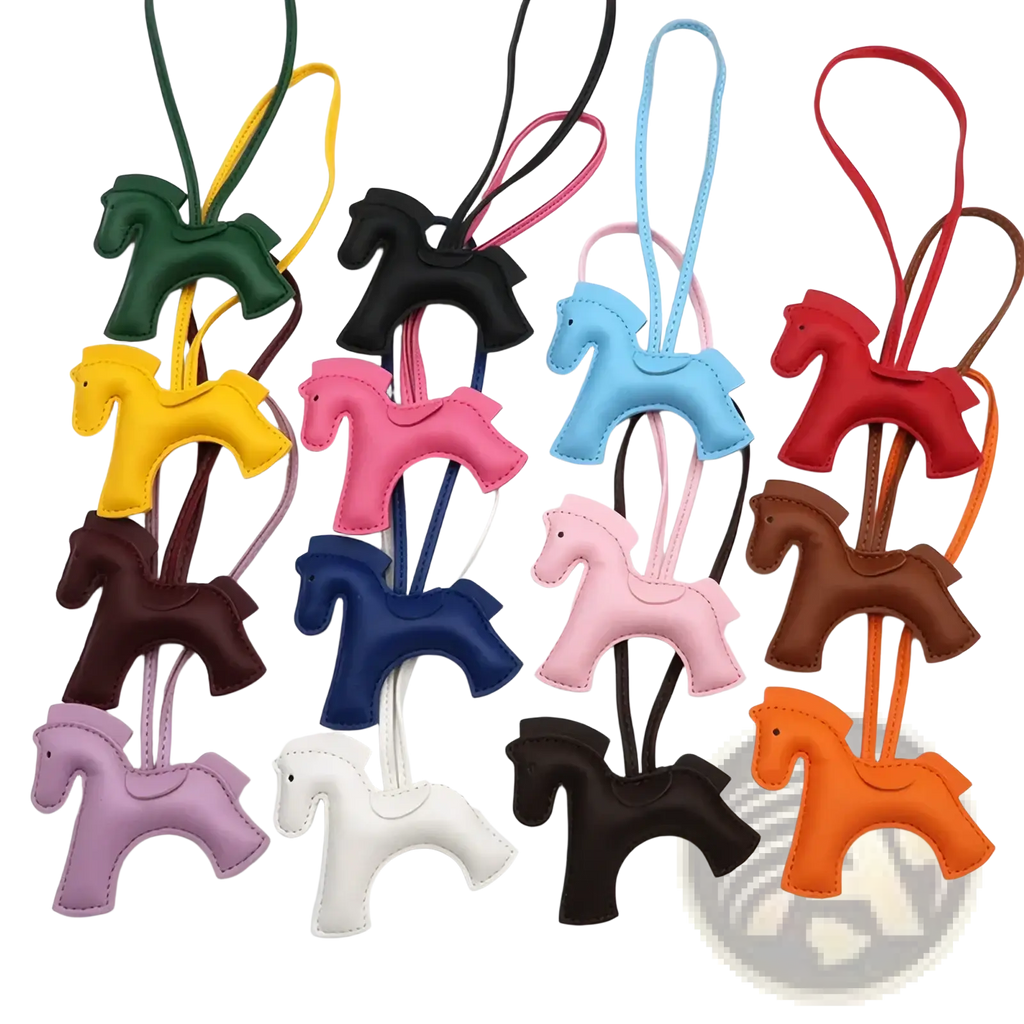 A collection of colorful stitched leather horse bag charm keychains in green yellow pink blue red brown purple white and orange