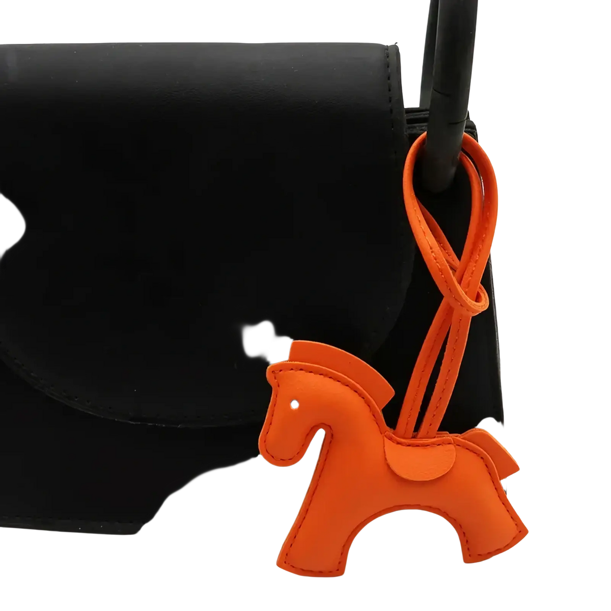 Orange leather horse bag charm keychain with a looped strap attached to a black bag handle