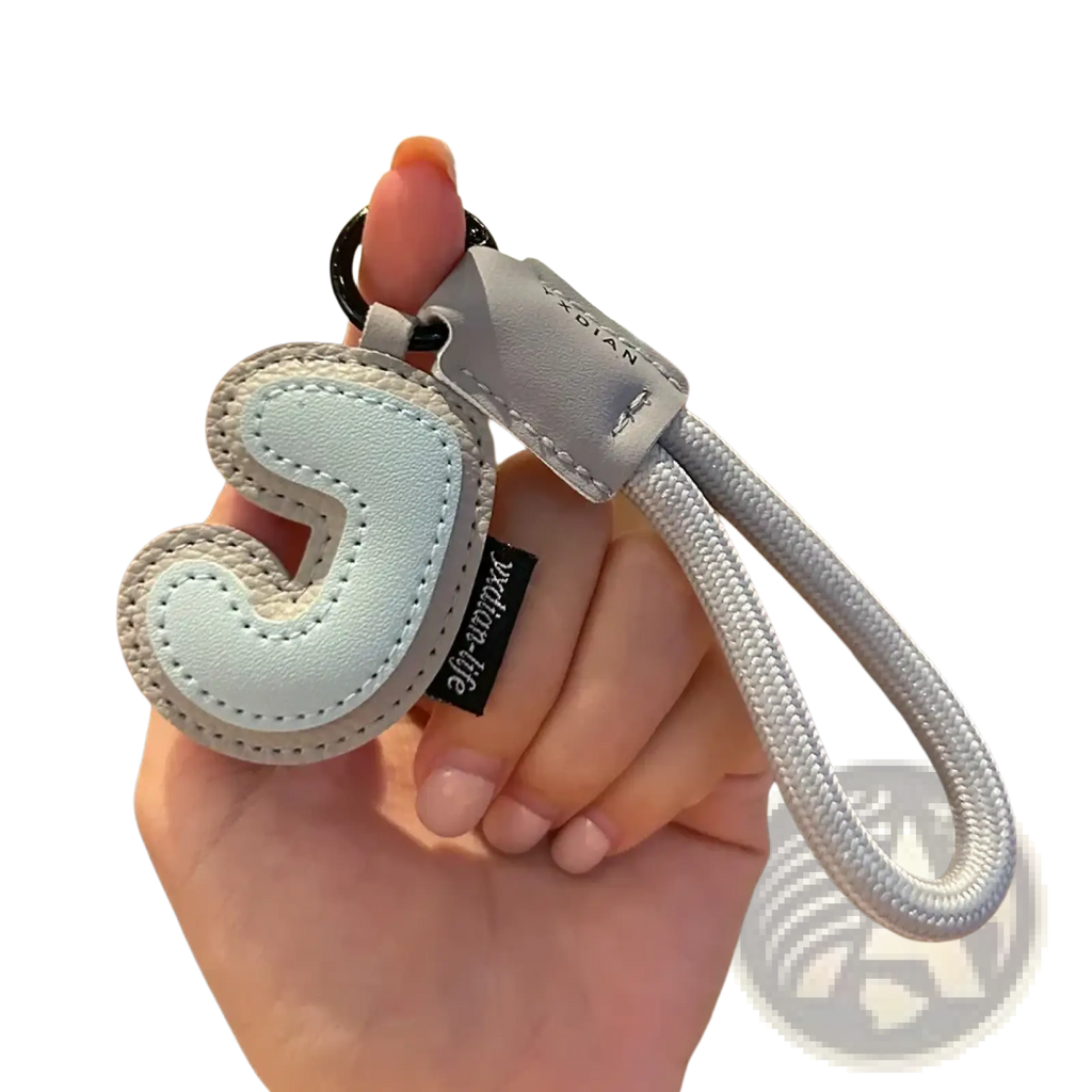 Light blue leather initial keychain with stitched letter j and silver-toned rope strap wristband charm