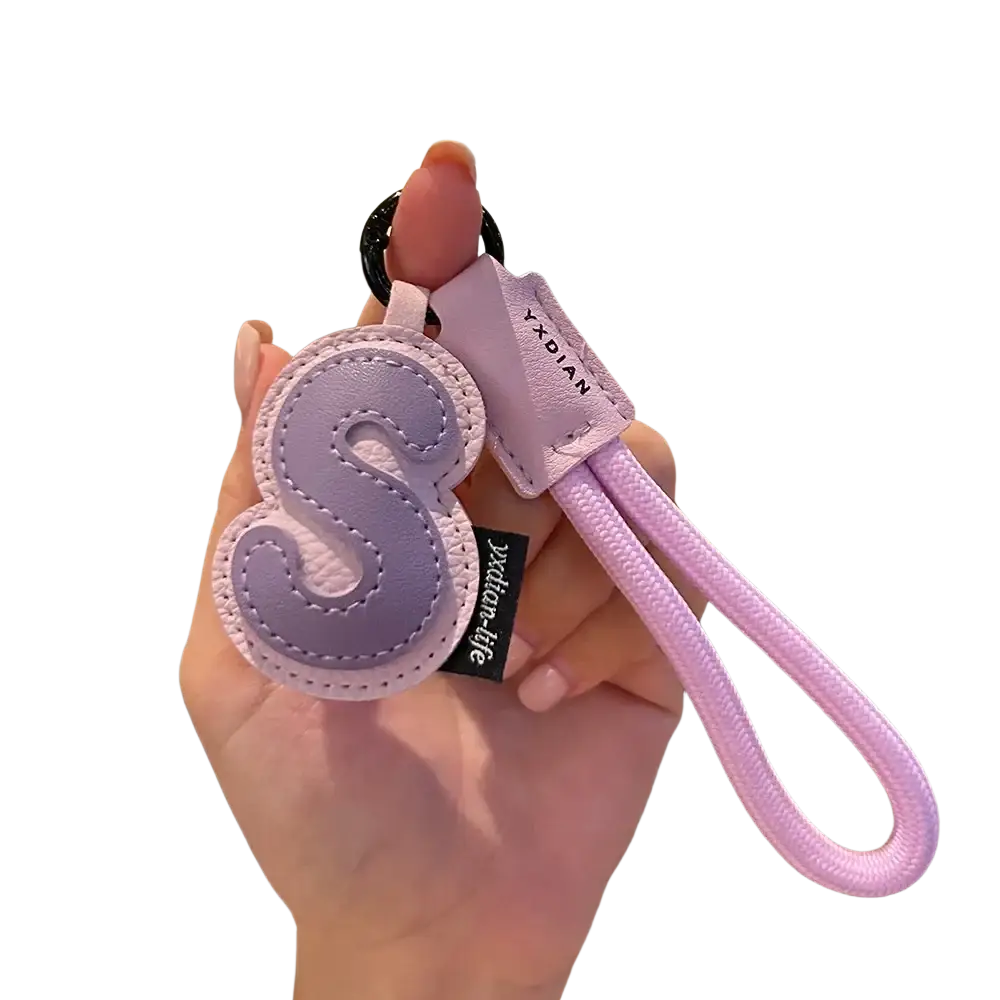 Lavender leather initial keychain with stitched letter s charm and matching braided wristband strap