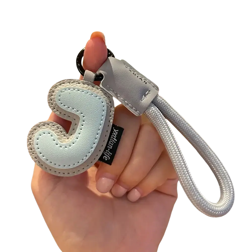 Light blue leather initial keychain with stitched letter j and silver-toned rope strap wristband charm