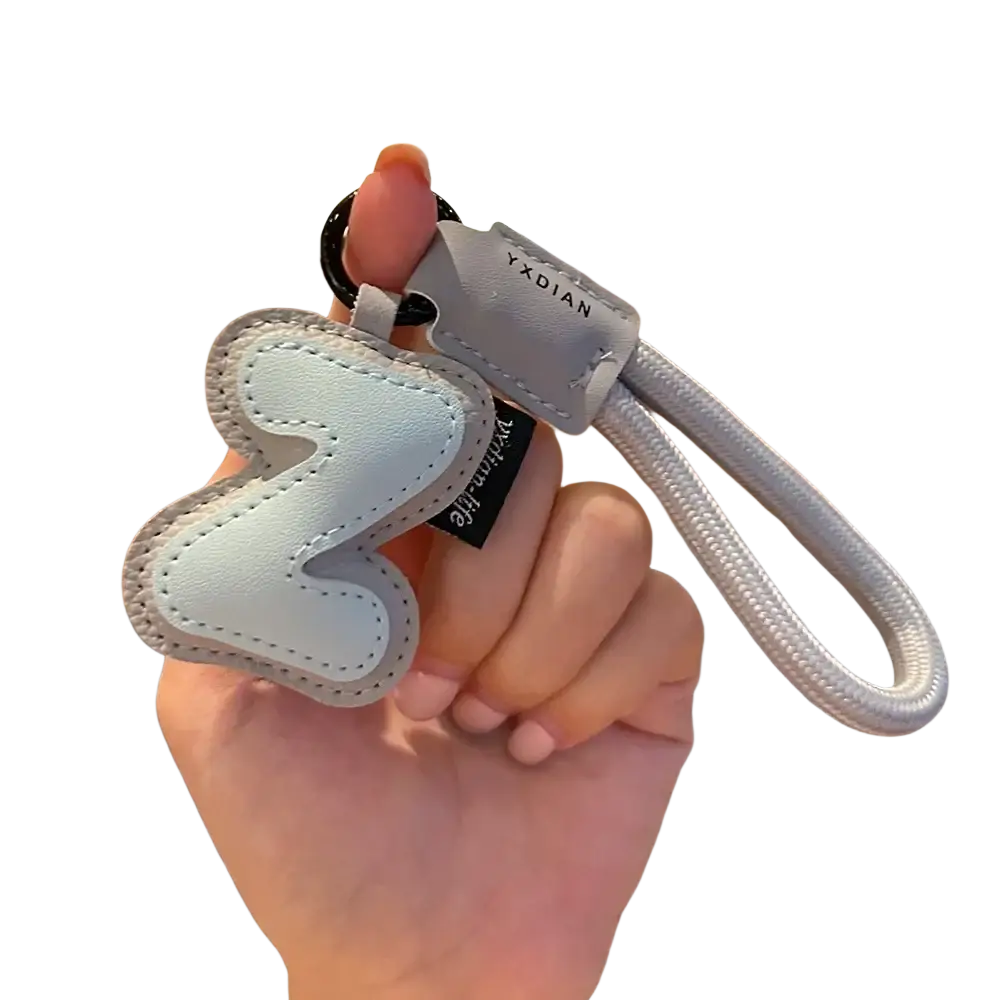 Light blue leather initial keychain wristband charm with stitched letter z and silver-toned metal tag