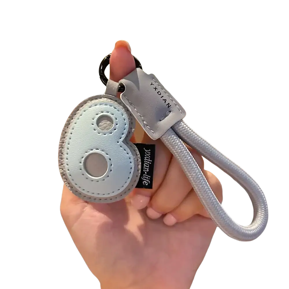 Light blue leather initial keychain shaped like number eight with silver braided strap and black metal ring charm