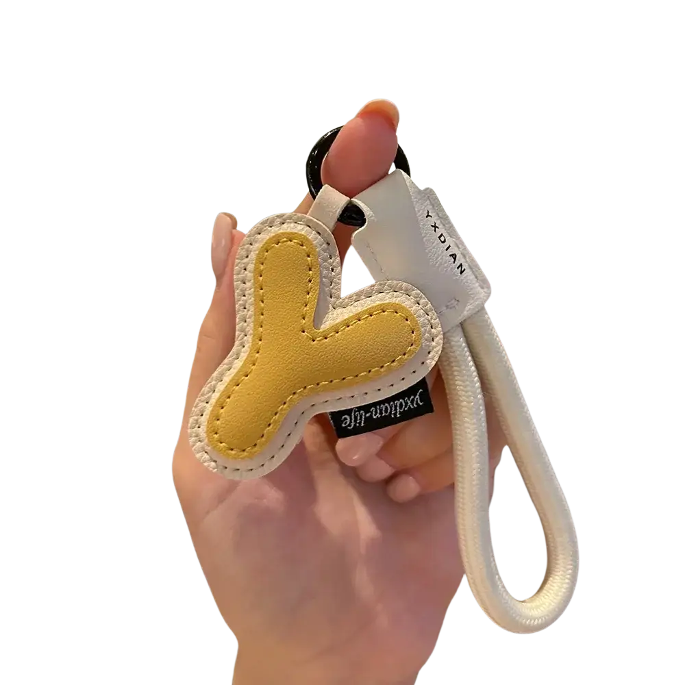 Yellow and white leather initial keychain shaped like letter y with braided strap wristband charm