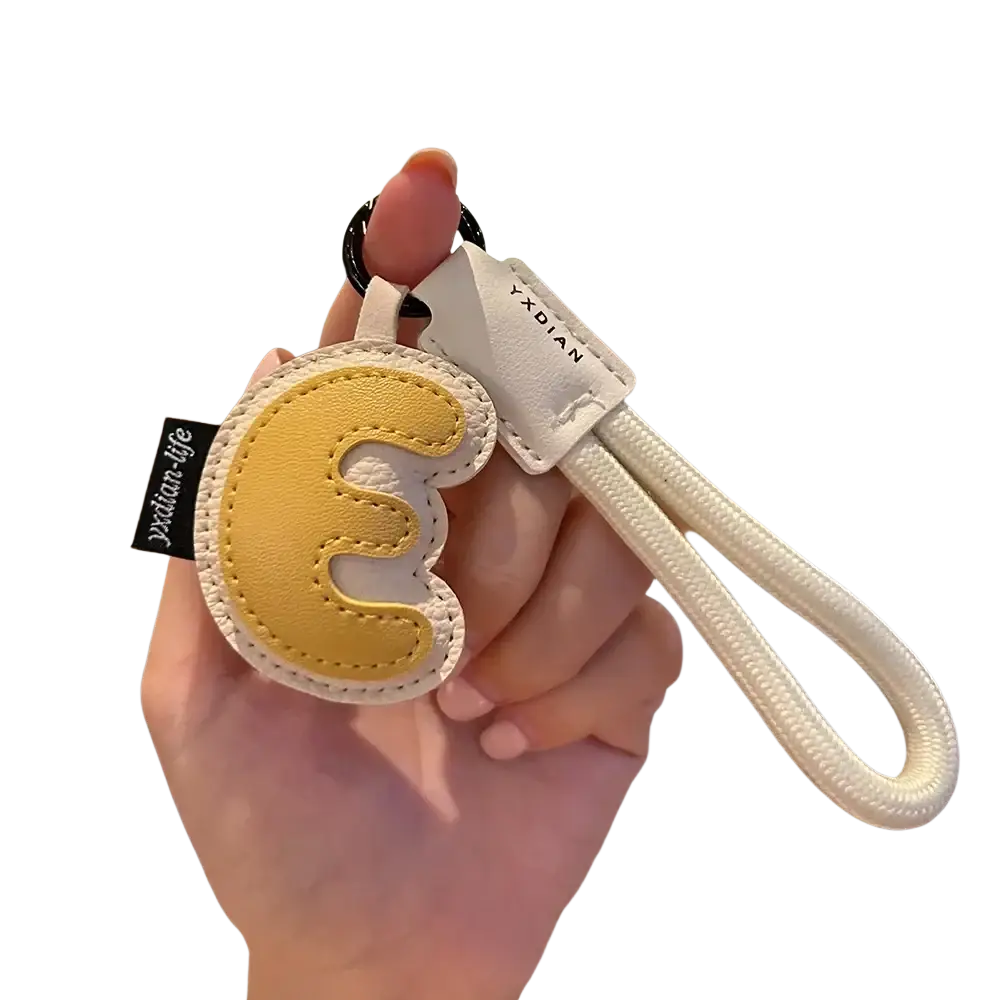Yellow and white leather initial keychain wristband charm with stitched letter e design