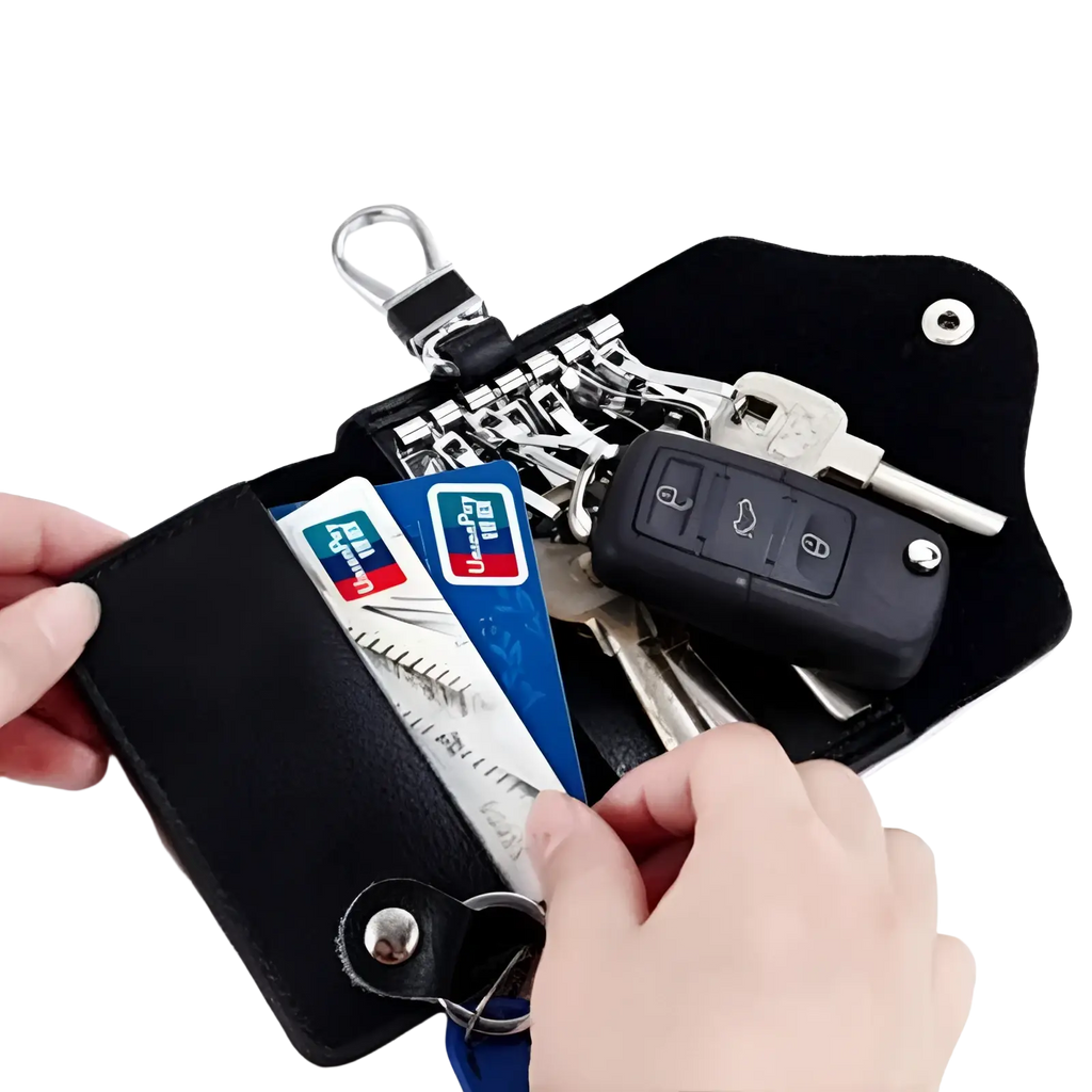 Black leather key case wallet organizer with silver metal clasp and snap closure holding keys and credit cards