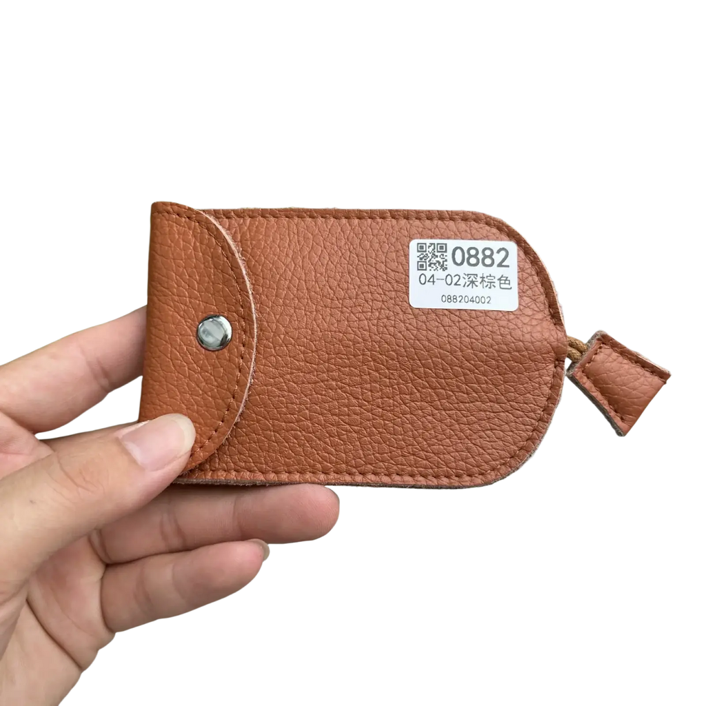 Brown textured leather key wallet case pocket holder with silver snap button and small looped strap for keys