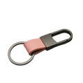 A sleek pink leather keychain with a matte black metal carabiner and ring for anti lost waist use