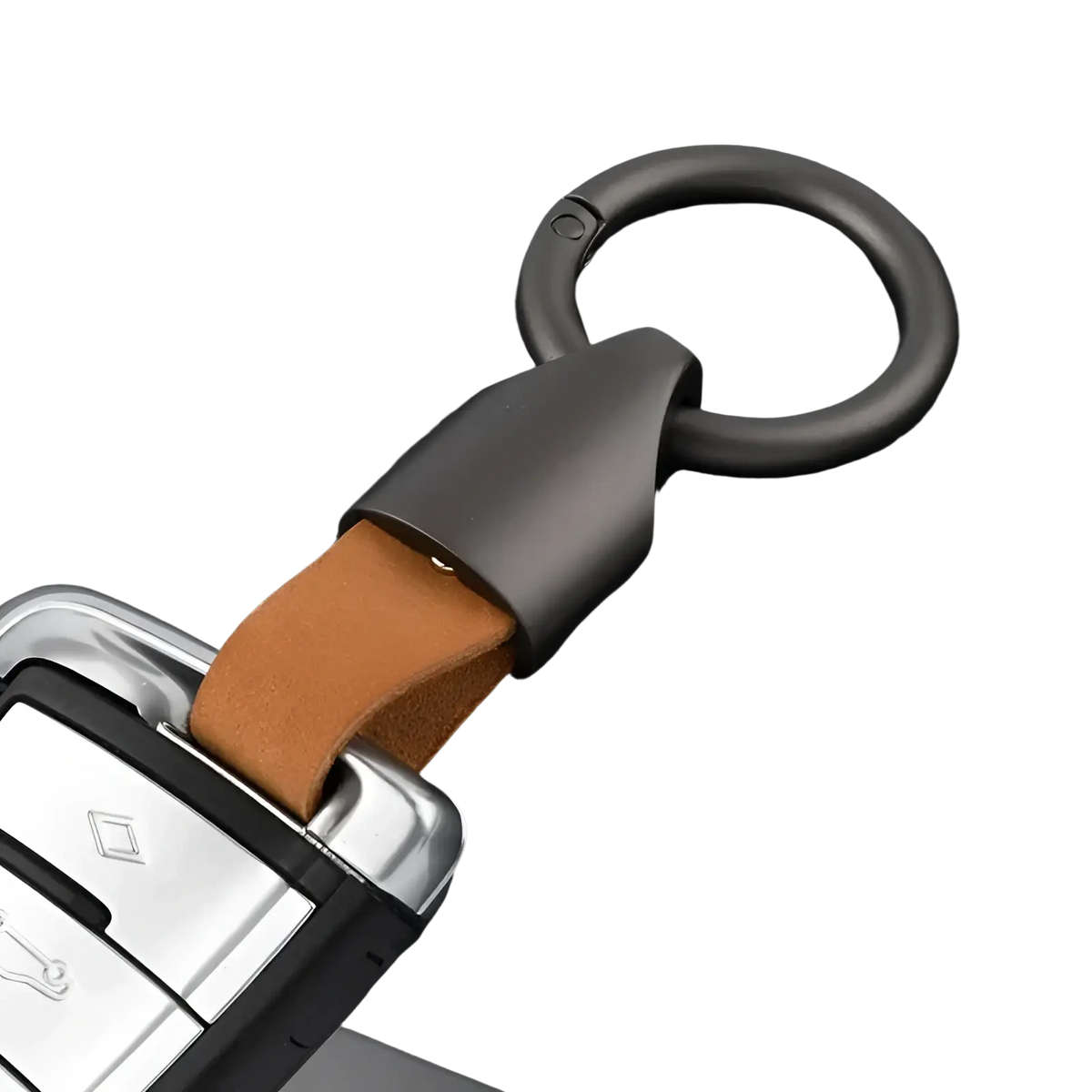 Dark gray metal leather keychain with tan leather strap attached to a car key fob for bag charm use