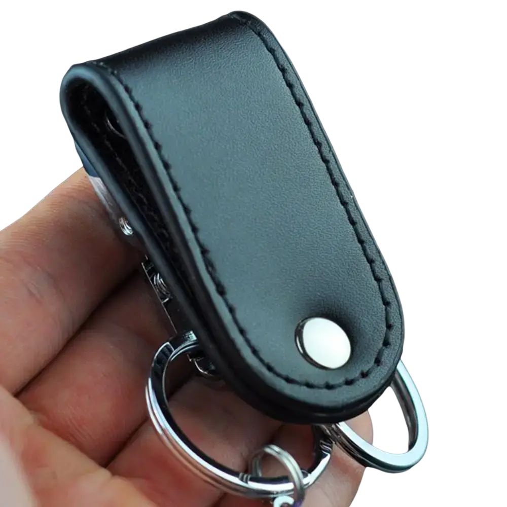 Black leather keychain with silver-toned metal clip ring and snap button closure for secure key holding