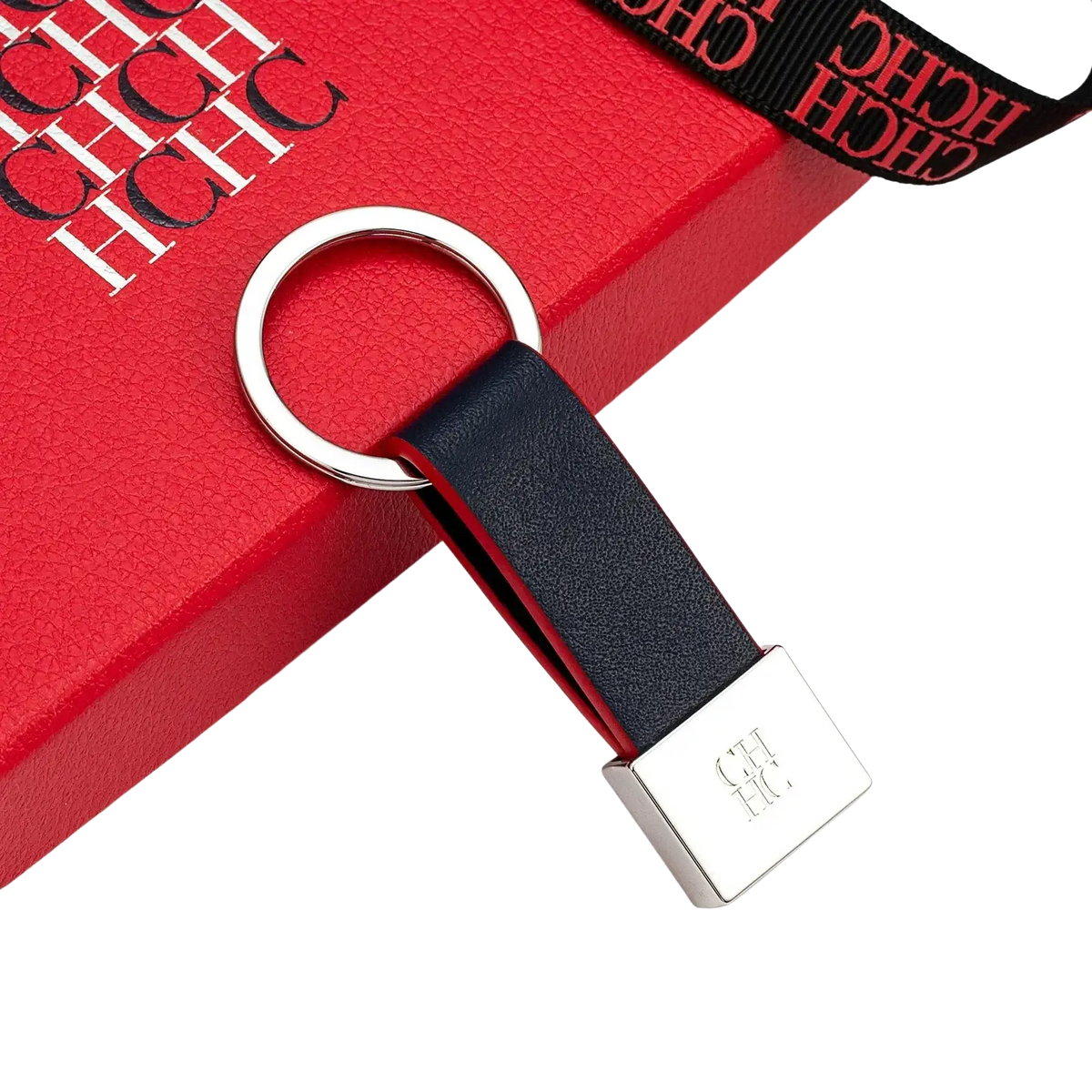 Black leather keychain with silver metal ring and rectangular plate featuring hch logo minimalist luggage accessory