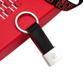 Black leather keychain minimalist luggage accessory with silver metal ring and engraved ch logo on rectangular plate