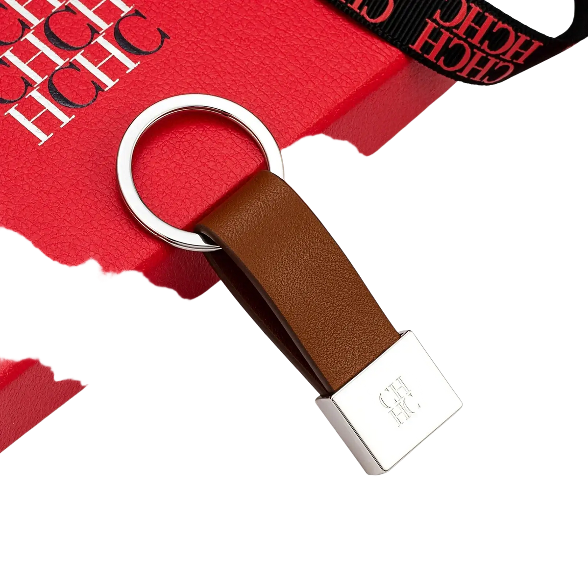 Brown leather minimalist luggage keychain with silver ring and rectangular plate engraved with ch logo