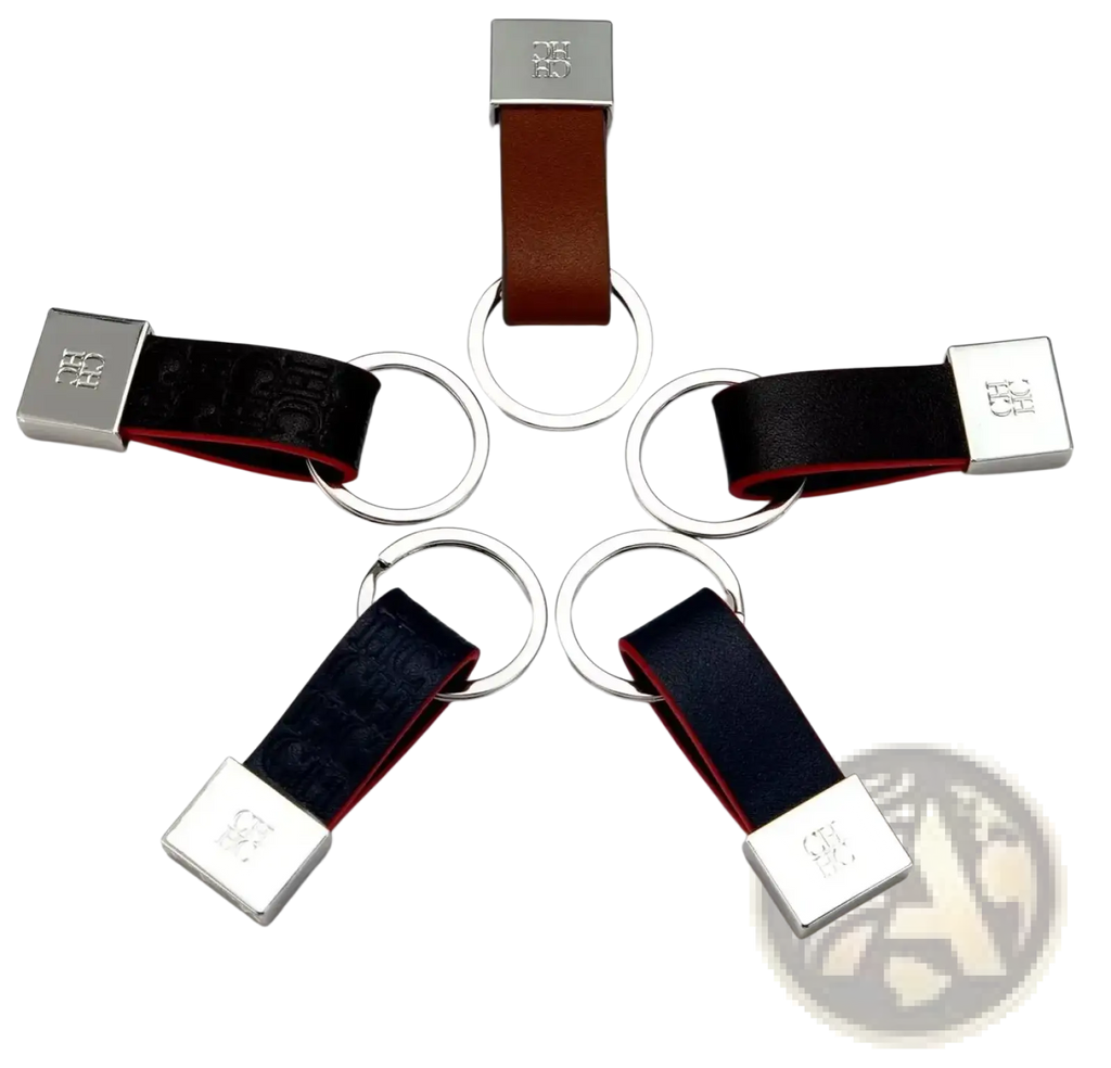 Leather keychain minimalist luggage accessory in brown and black leather with silver logo plate and circular ring attachments