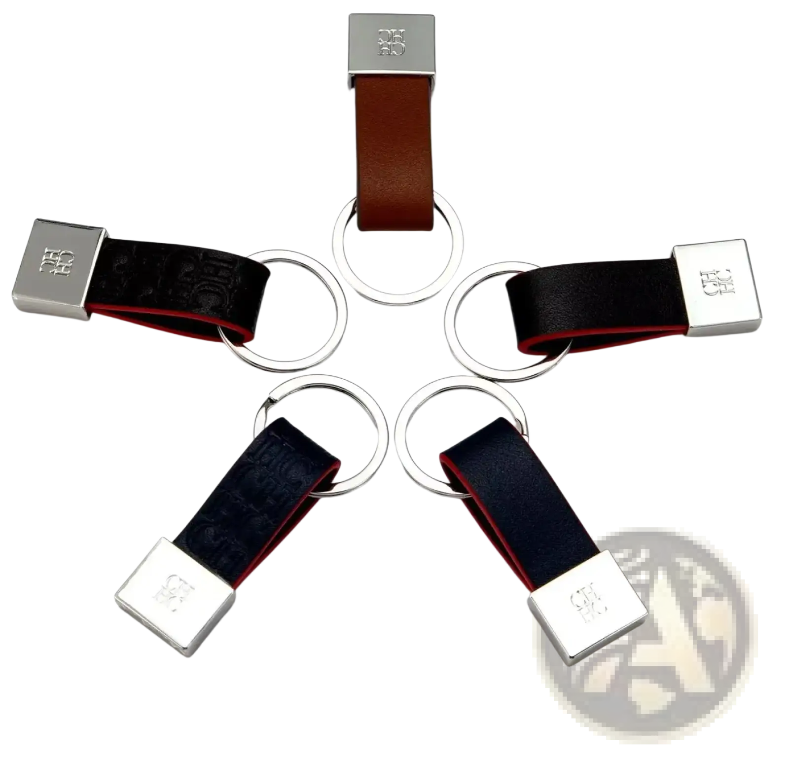 Leather keychain minimalist luggage accessory in brown and black leather with silver logo plate and circular ring attachments