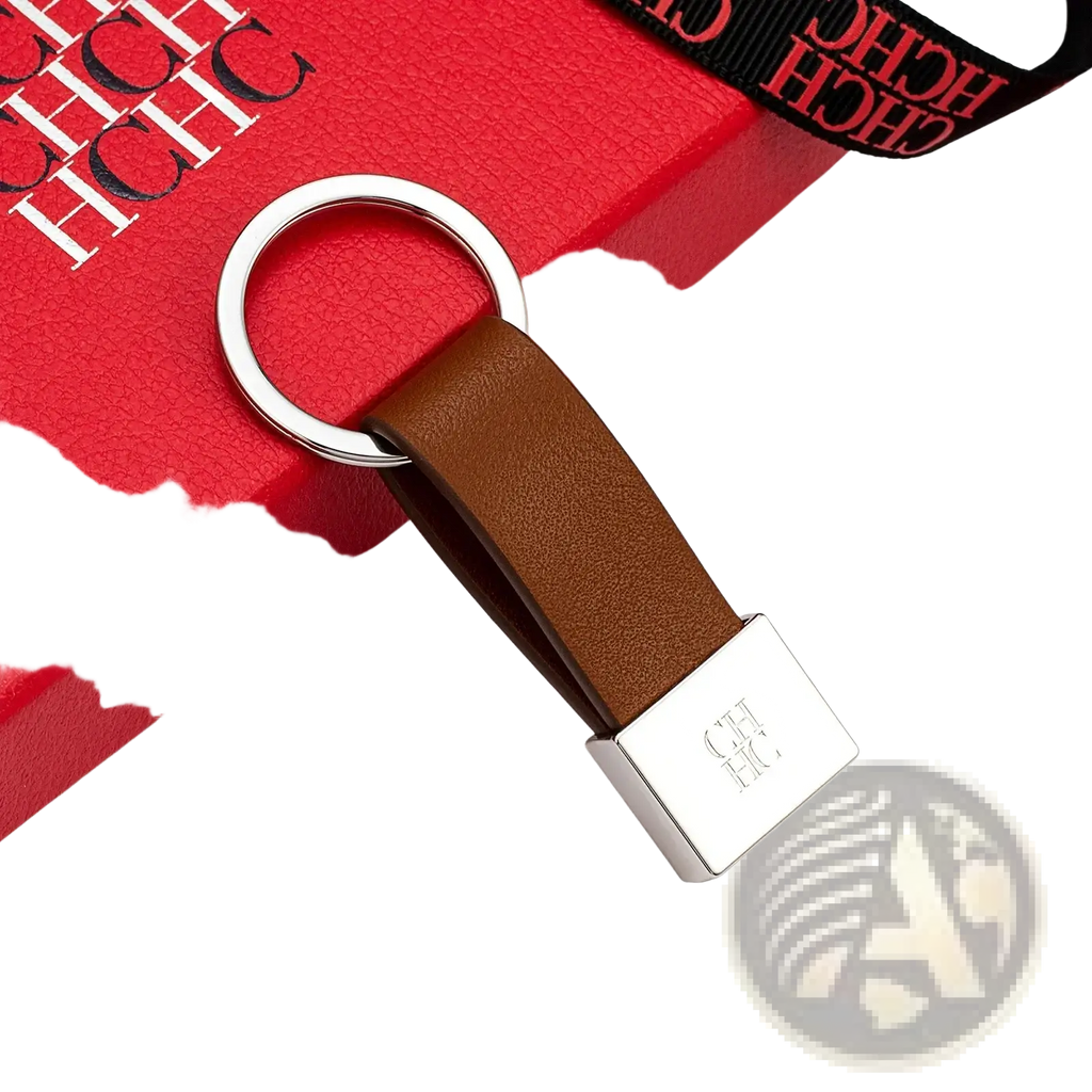 Brown leather minimalist luggage keychain with silver ring and rectangular plate engraved with ch logo
