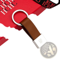 Brown leather minimalist luggage keychain with silver ring and rectangular plate engraved with ch logo