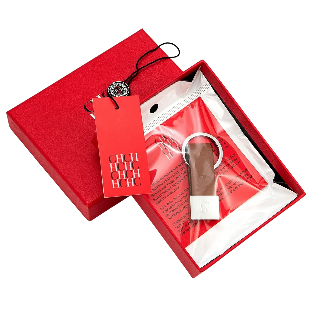 A sleek minimalist leather keychain with a silver metallic ring and brown leather strap for luggage accessory use