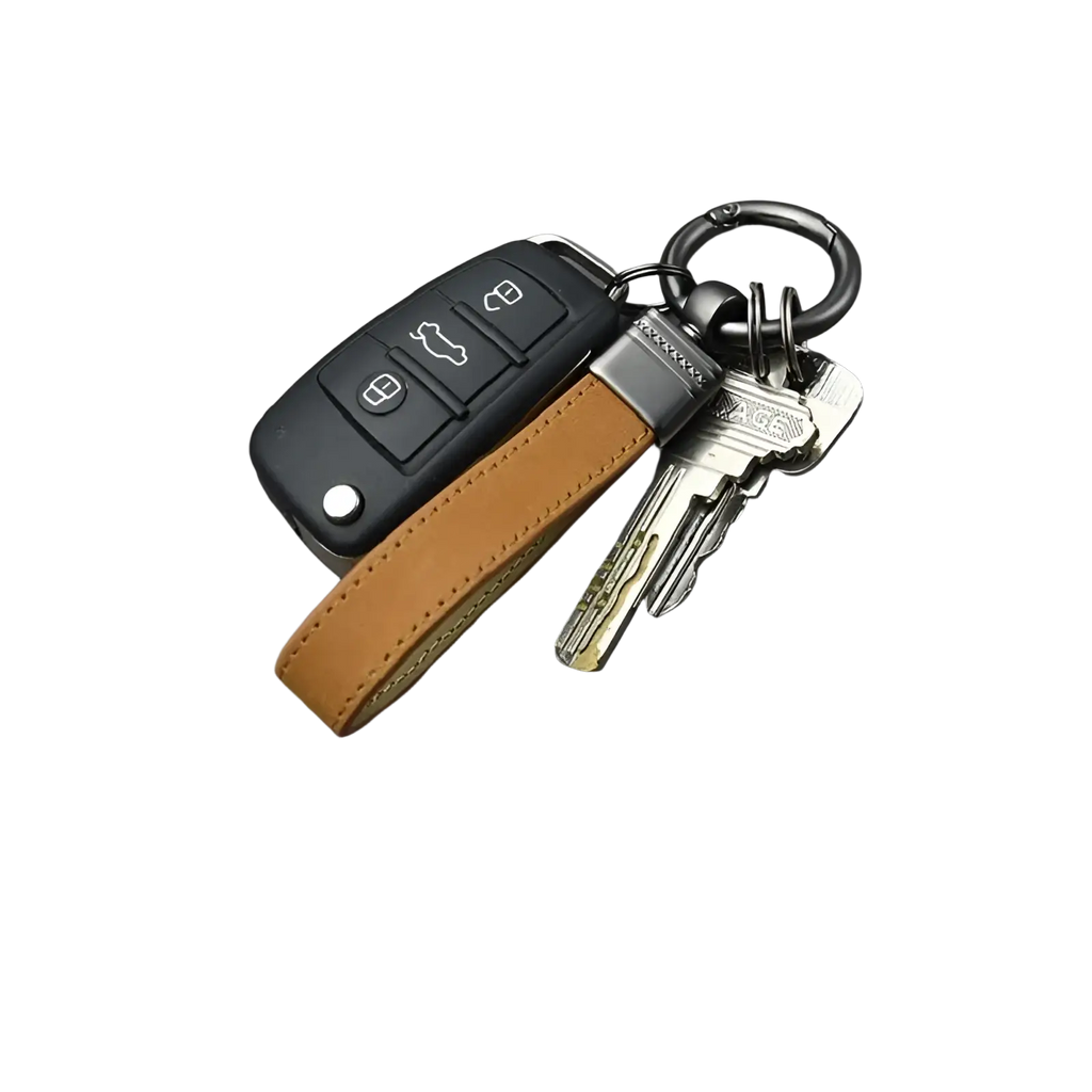 Tan leather keychain with a silver metal clasp attached to a black car remote and multiple keys from a multicolor set