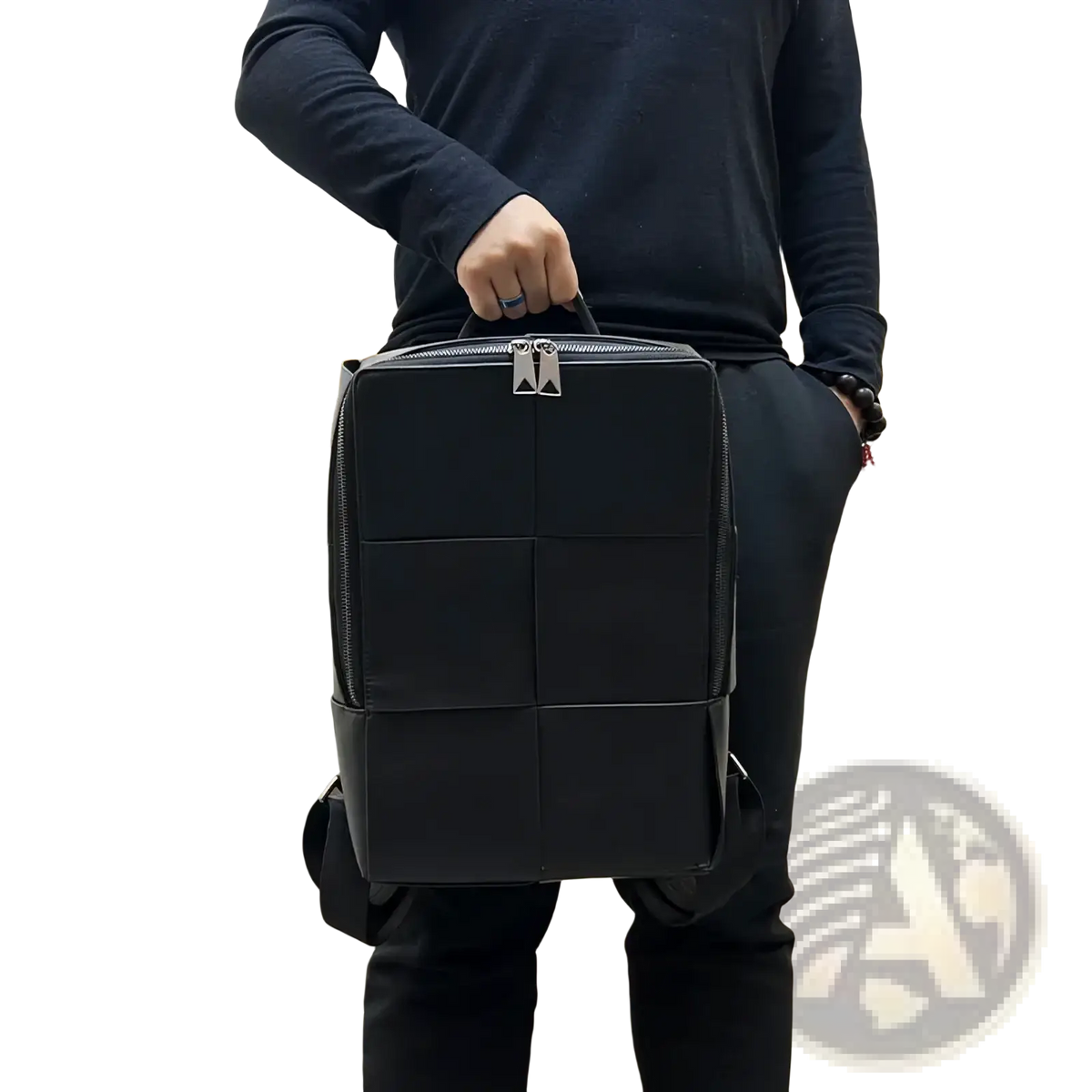 Black quilted leather laptop backpack for men with silver-toned zippers and structured rectangular design