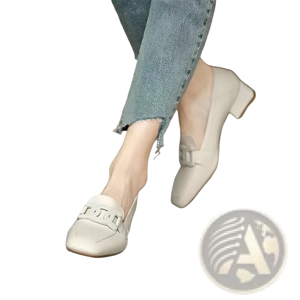 Beige leather loafers with a square toe small block heel and decorative metal buckle across the vamp