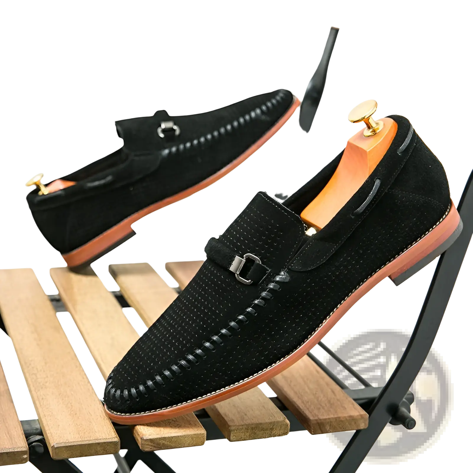 Black leather loafers with perforated suede texture, stitched detailing, and metallic buckle strap slip on shoes