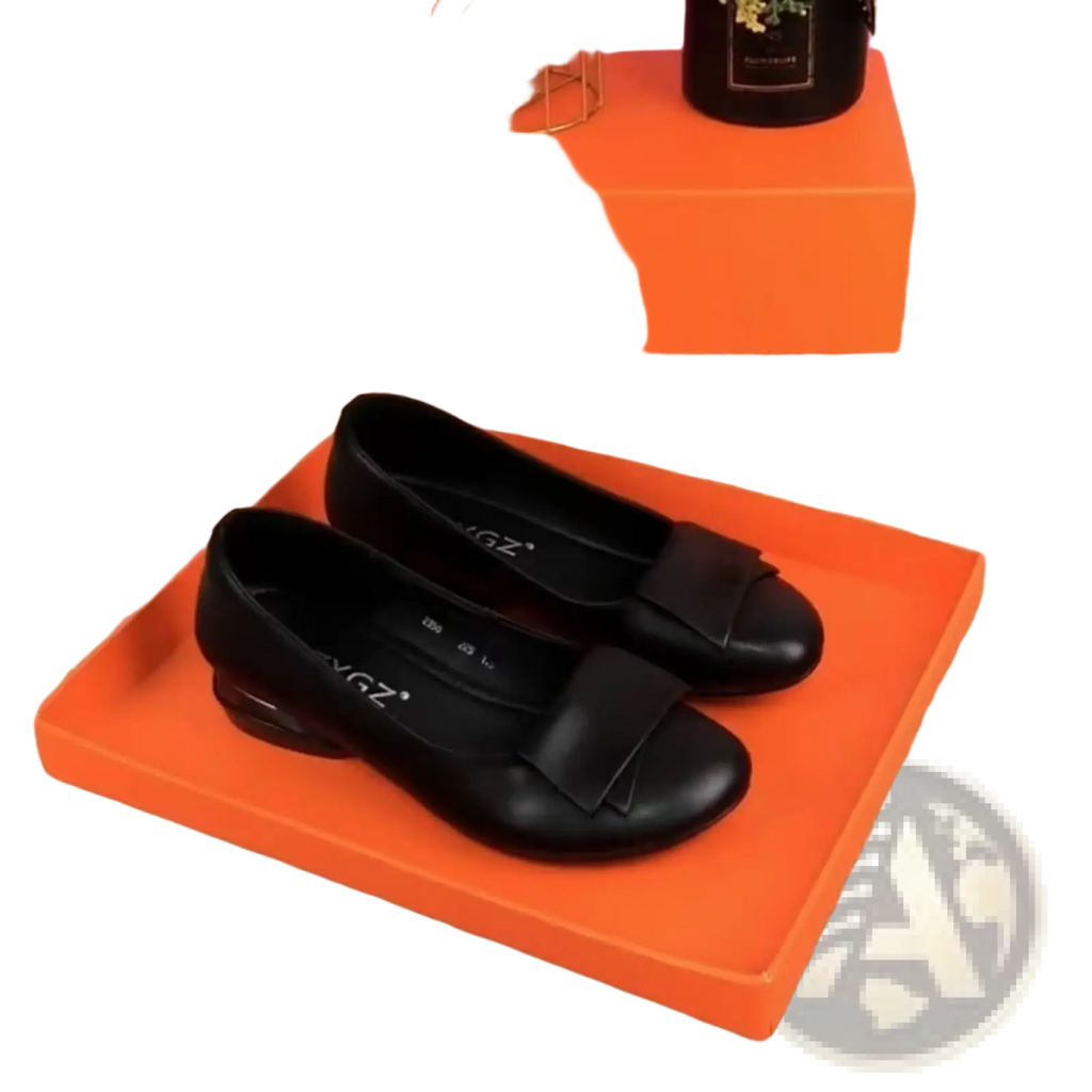 Black leather loafers with square toe and bow detail on the toe, showing the front view of the flat shoes