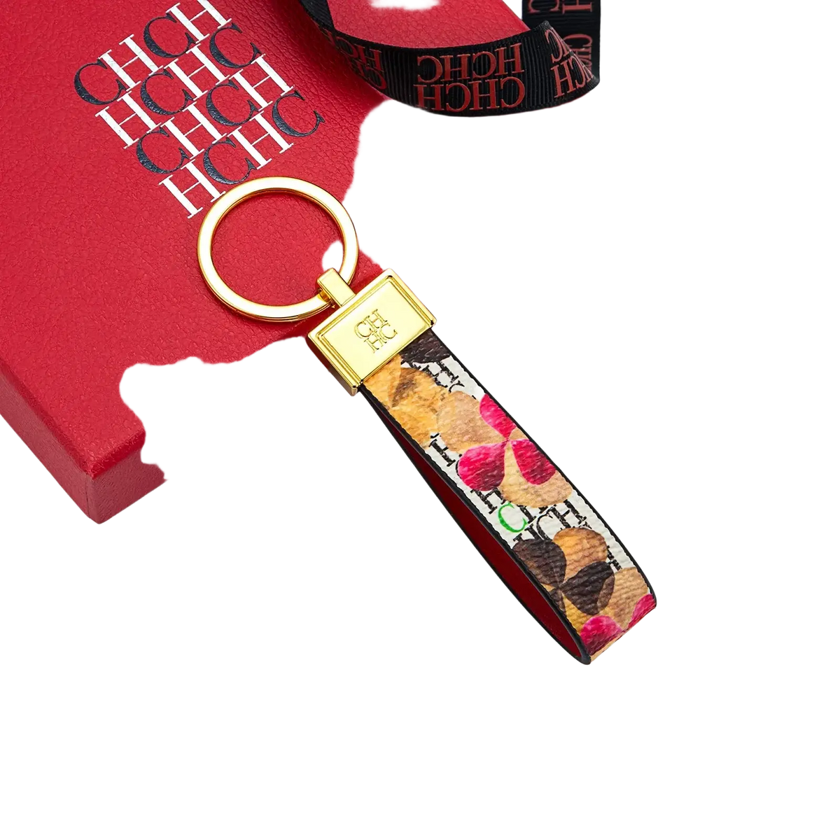 Gold-toned leather logo keychain with rectangular metallic clasp and vibrant floral fabric strap for designer fashion accessory gift