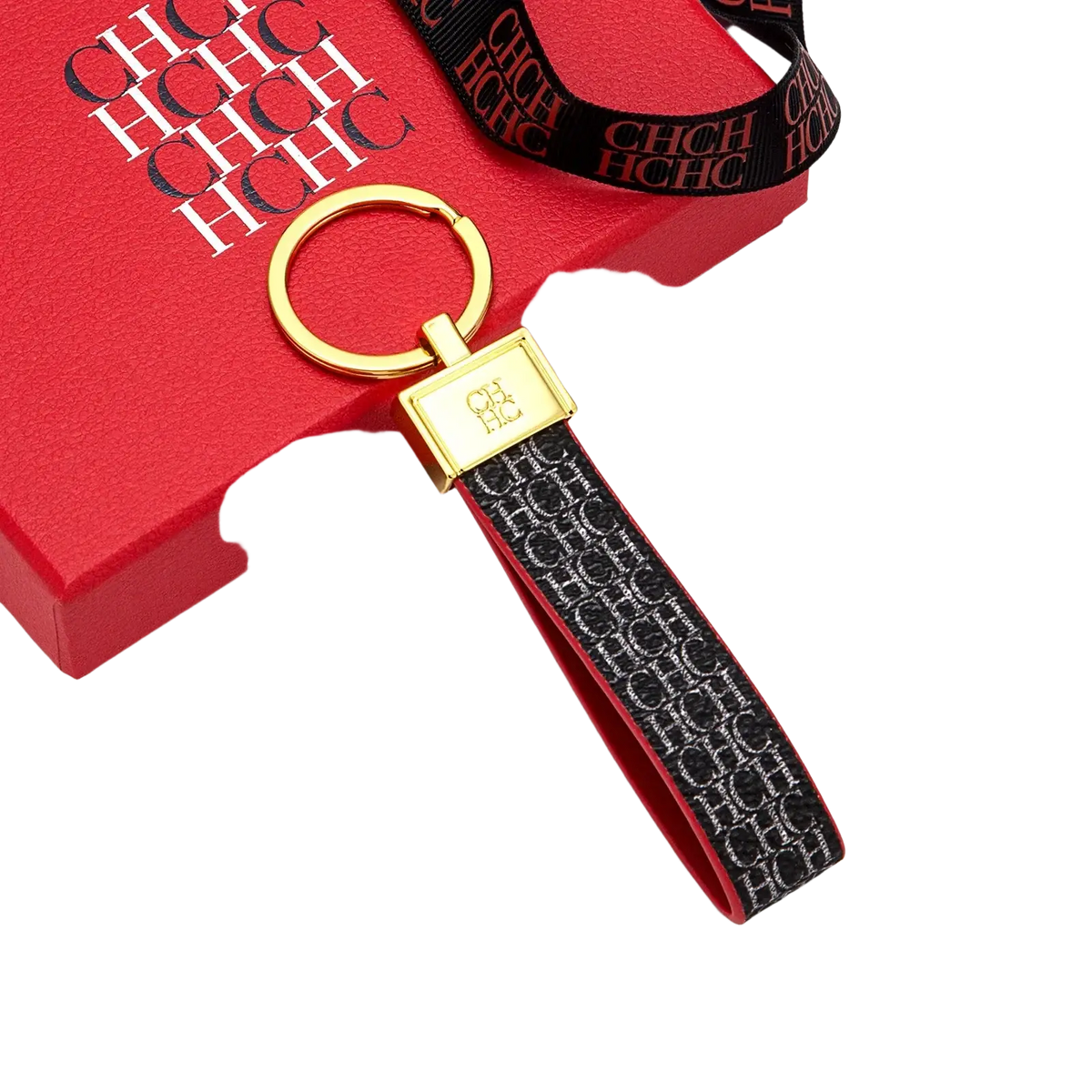 Gold-toned leather logo keychain with black strap featuring silver ch monogram and gold-plated rectangular plaque