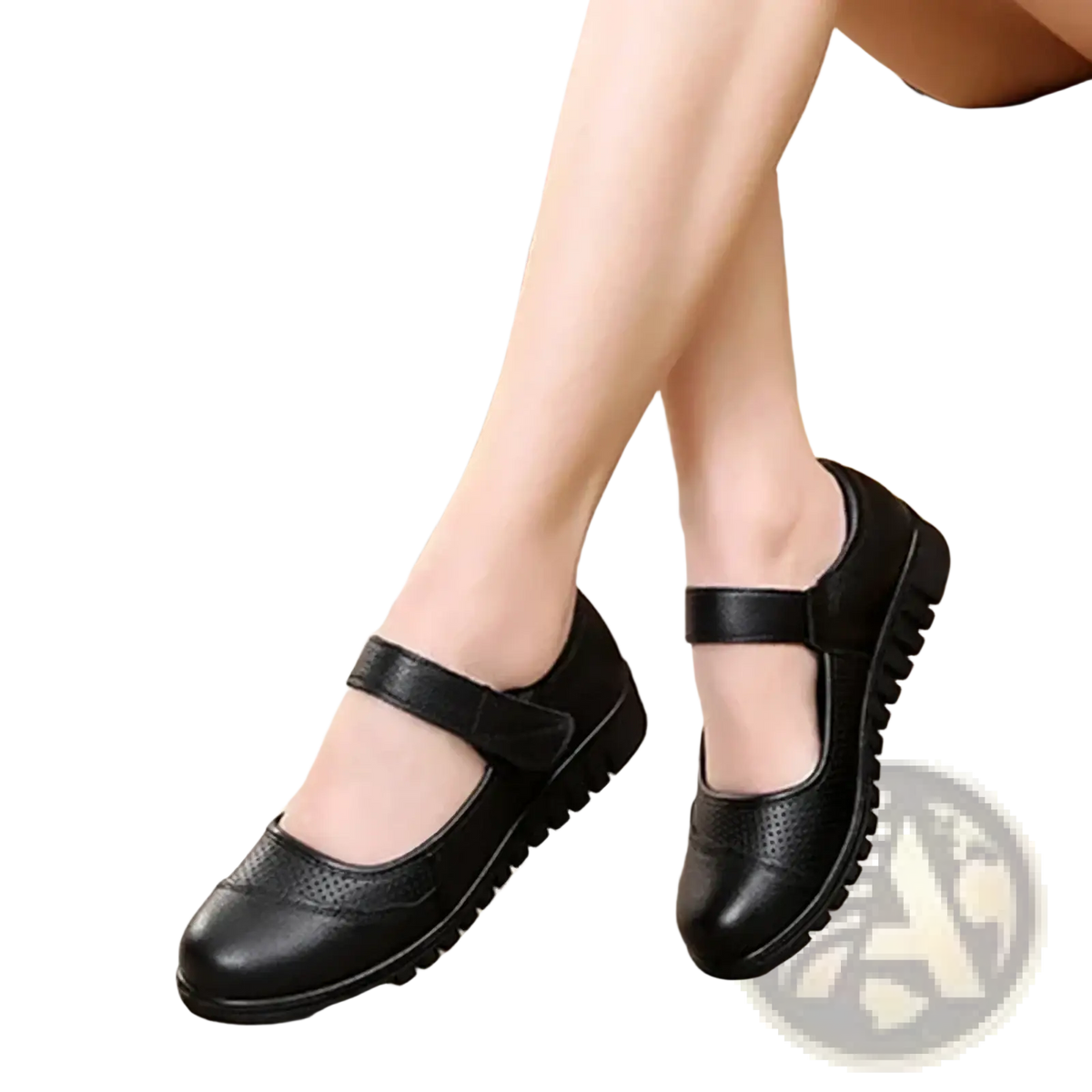 Black leather mary jane flats with a strap across the foot and perforated detailing on the toe