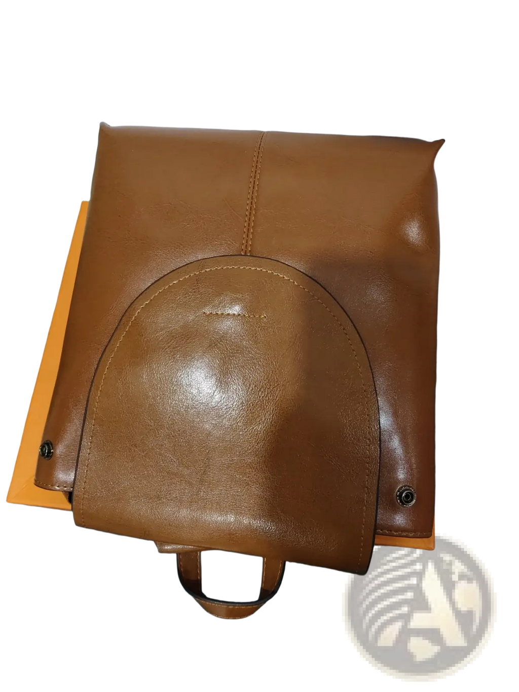 A tan leather messenger backpack with a curved front flap and matching handle in retro fashion style