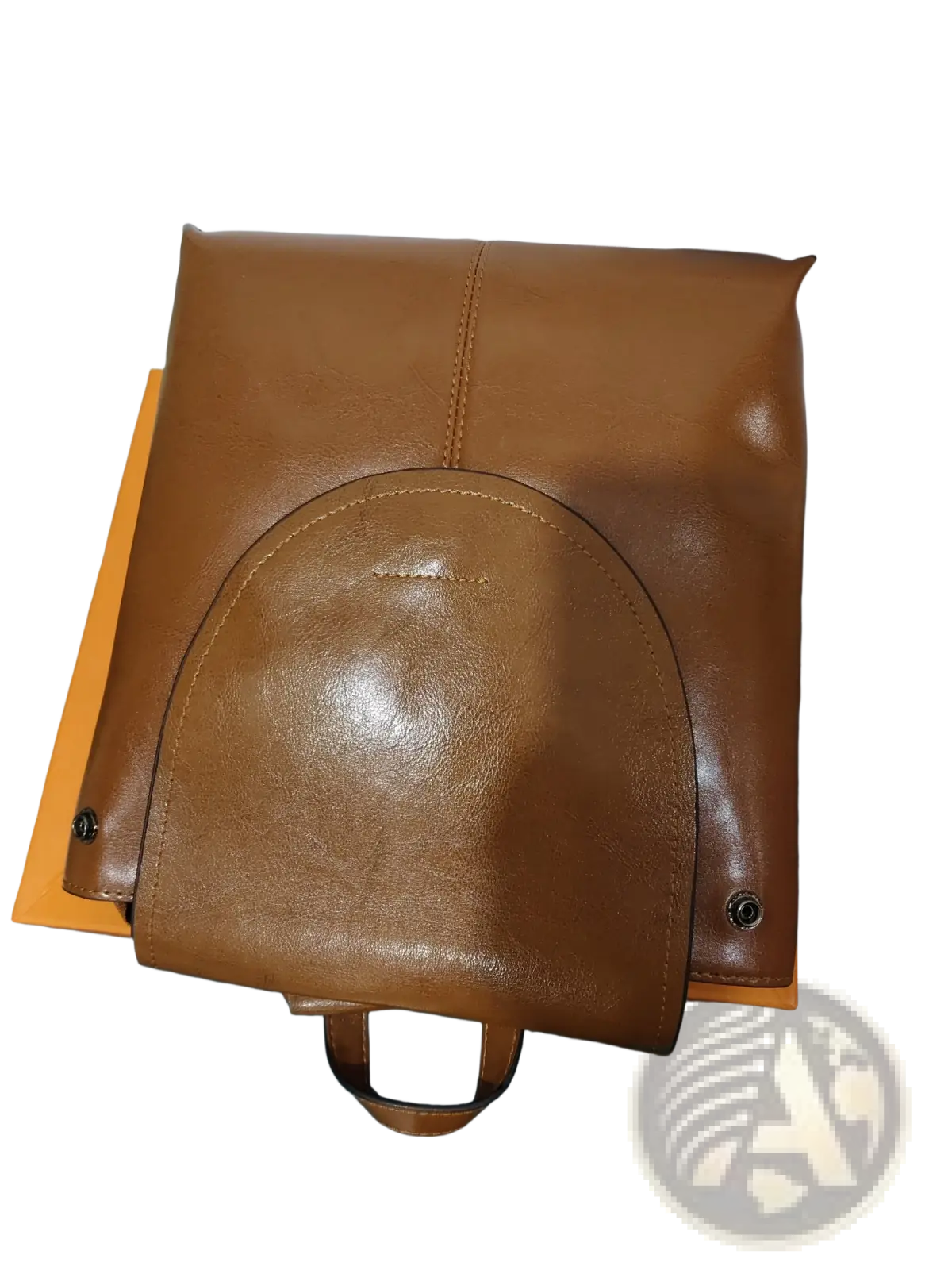 A tan leather messenger backpack with a curved front flap and matching handle in retro fashion style