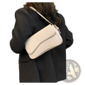 Cream-colored leather messenger bag with smooth leather-like material and minimalist crossbody design