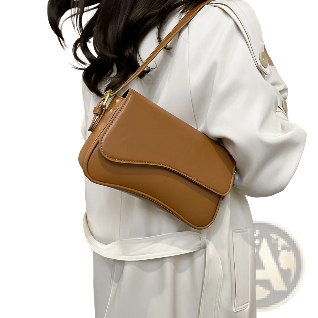 Tan leather messenger bag minimalist crossbody with sleek design and gold-tone hardware for organized use