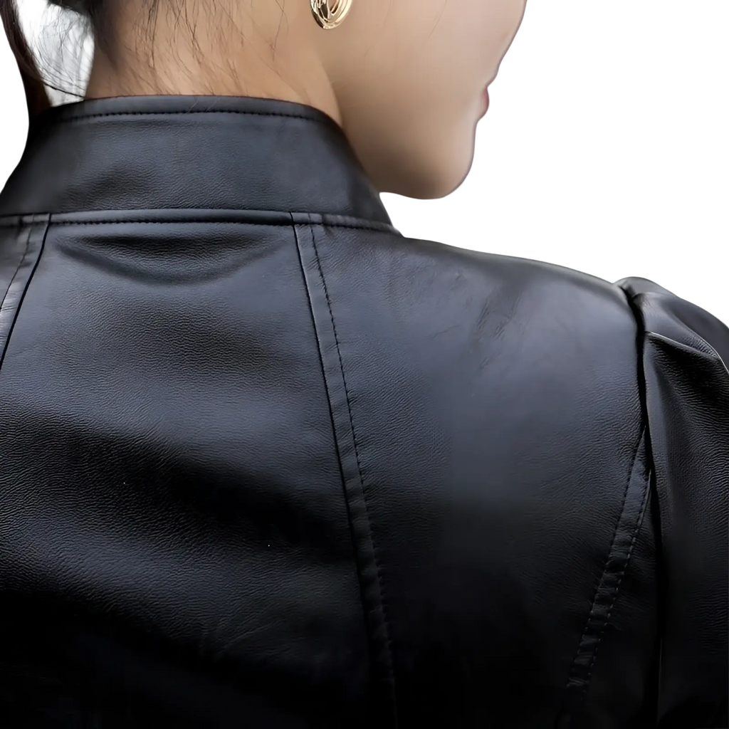 Black faux leather moto jacket with high collar and puff sleeves in a sleek modern design