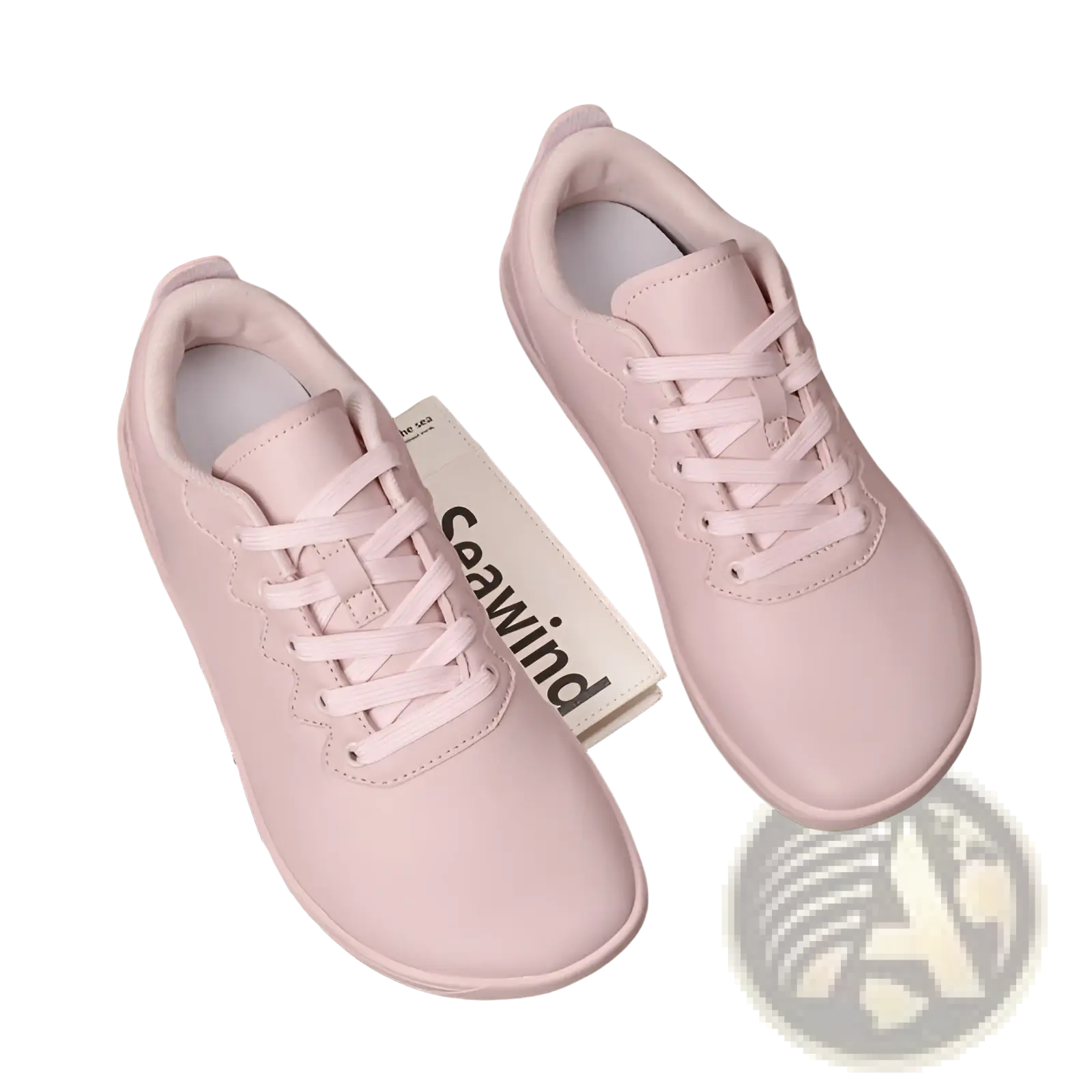 Pair of soft pink leather low-top sneakers with matching laces designed as minimalist casual outdoor shoes