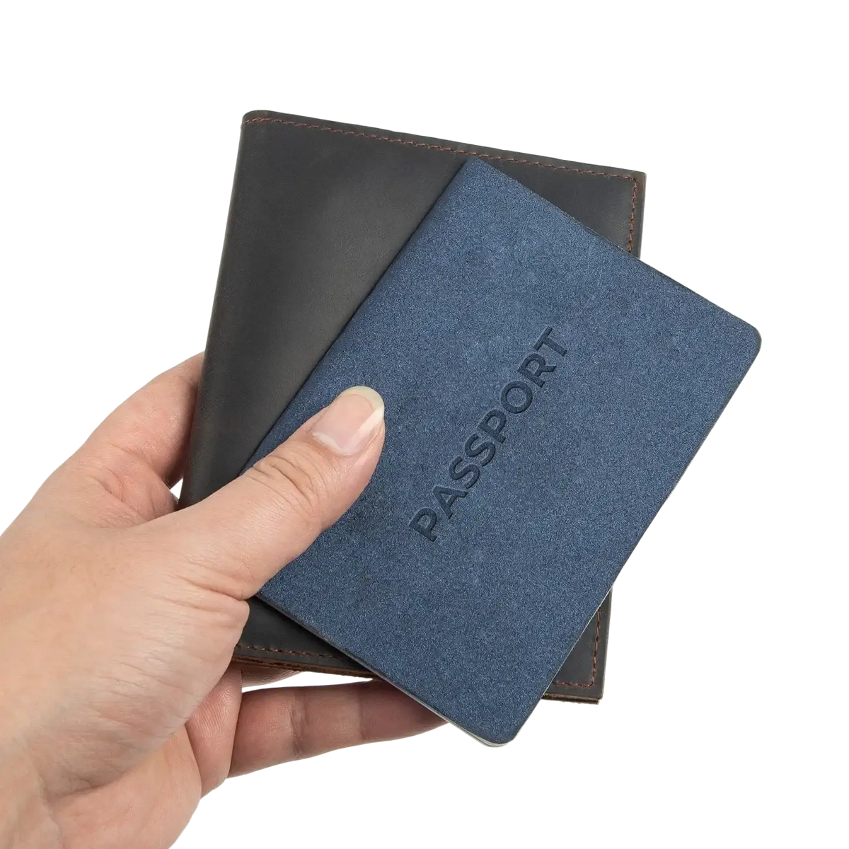 Blue textured leather passport holder with embossed passport text held against dark brown leather travel wallet