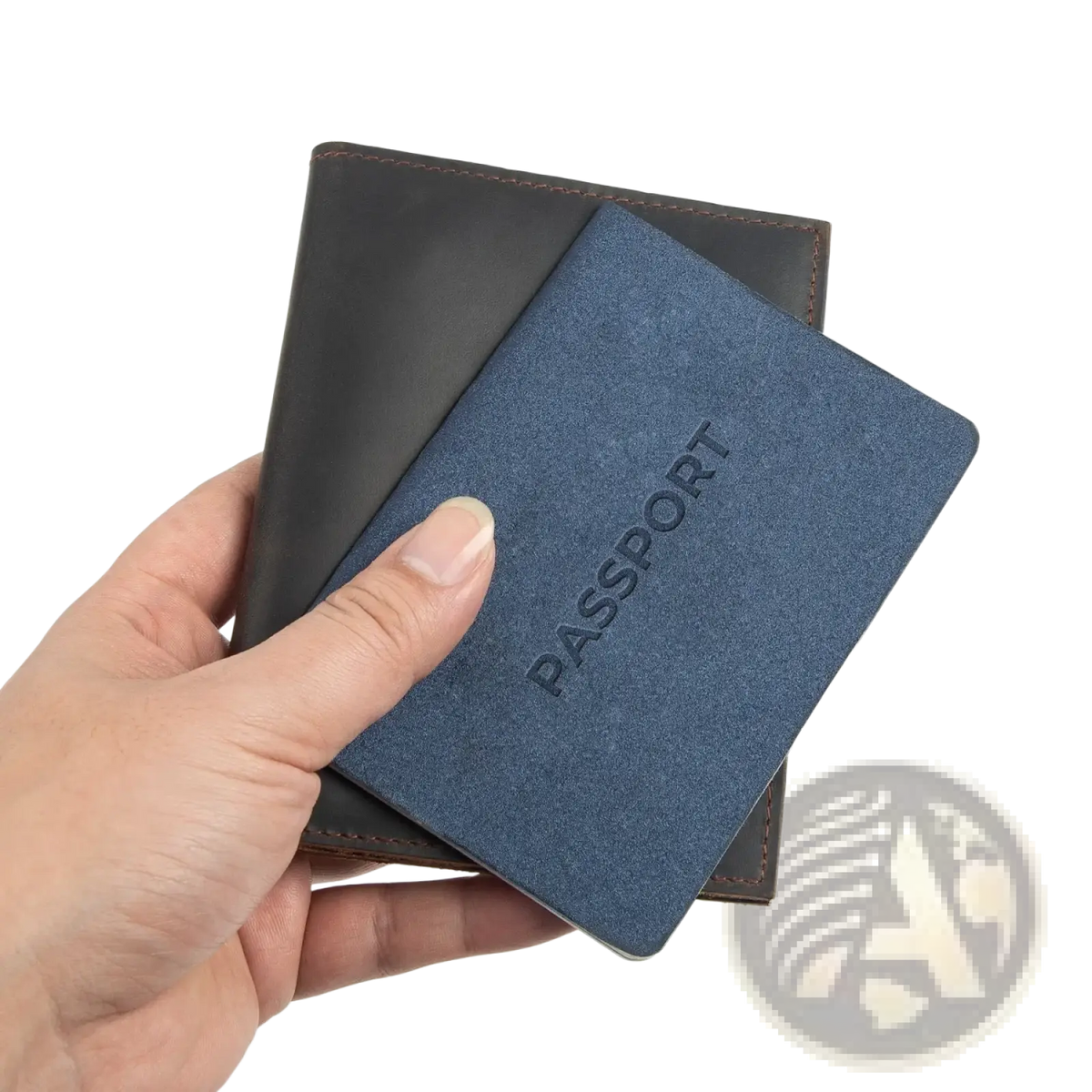 Blue textured leather passport holder with embossed passport text held against dark brown leather travel wallet