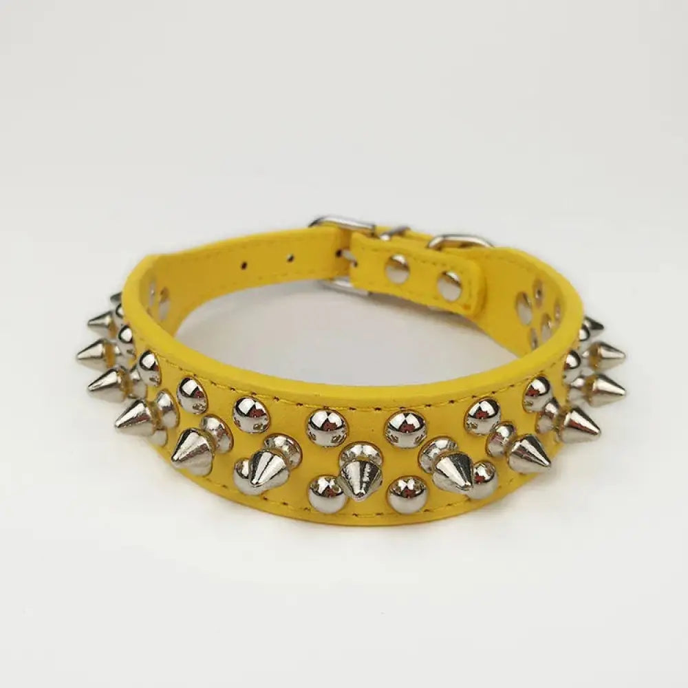 Bright yellow leather dog collar with silver-toned metal spikes and studs for small and medium breeds