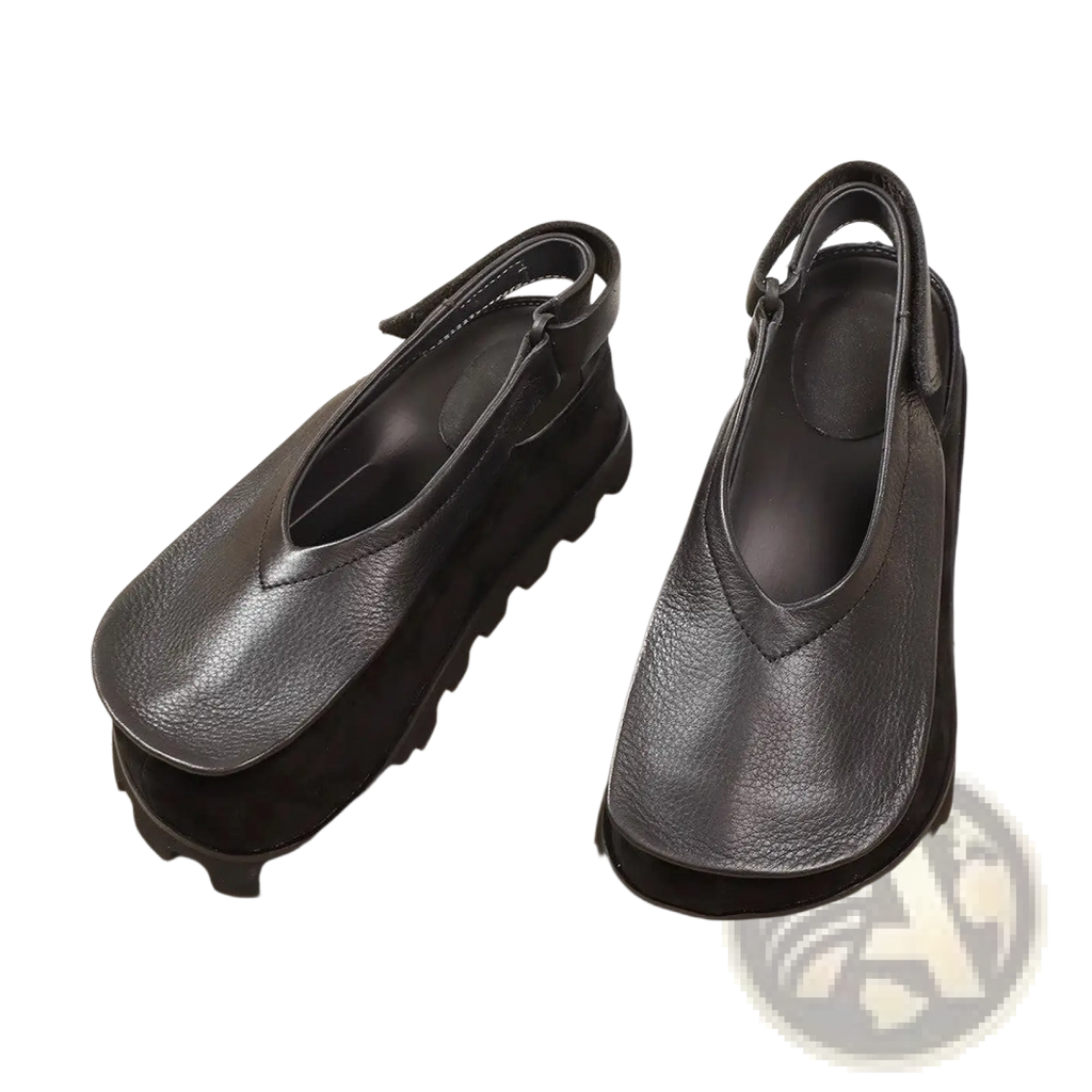 Black leather platform sandals with chunky sole open toe design and adjustable strap for a retro look