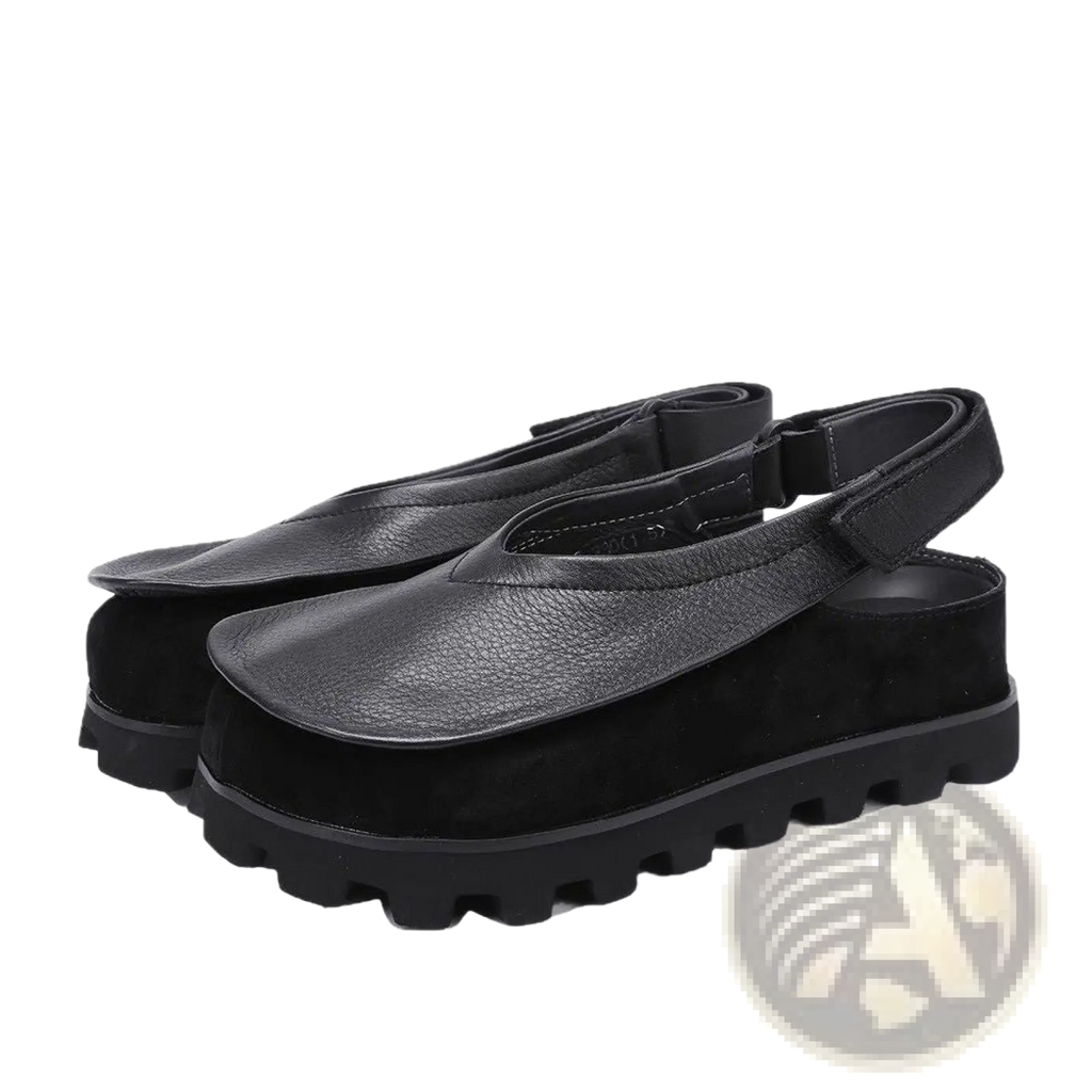 Black leather and suede chunky platform sandals with a strap across the foot and an open toe design