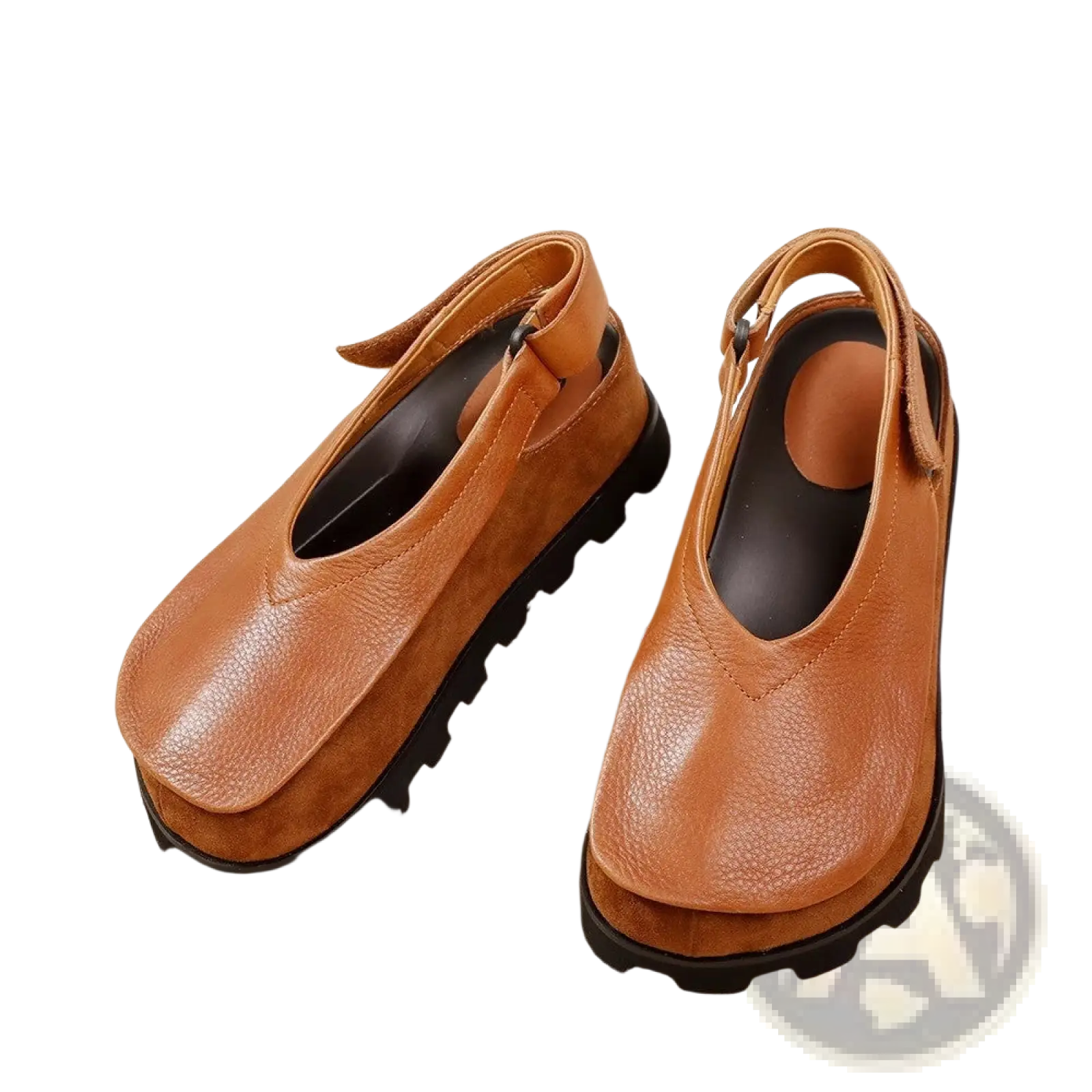 Tan leather platform sandals with chunky black sole and adjustable ankle strap in a retro open toe design
